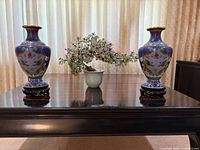 Pair of vases and soapstone tree on table