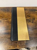 Closed album showing black and gold front cover
