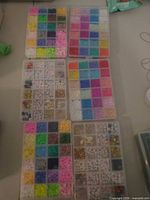 Six boxes with multicolor beads arranged by hue