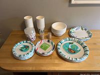 All packs and stacks of disposable serveware and toothpicks on counter