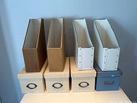 Overall view: four magazine holders and three lidded boxes on tabletop