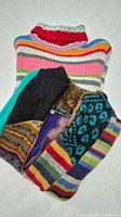 Stack showing striped turtleneck sweater on top of patchwork sweater jacket