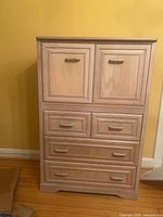Front view showing two cabinet doors over three tiers of drawers