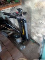Full view of log splitter standing upright against wall