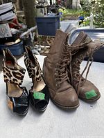 Both pairs of footwear side by side on table