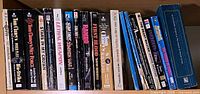 Full row of paperback books showing titles and spines