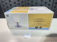 Factory-sealed retail box of Hampton Bay Dumant ceiling light showing product image and box wear