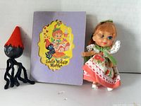 Doll, booklet front, octopus figure grouped