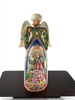 Front view of angel figurine displaying nativity scene