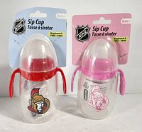 Front view showing both sip cups on retail cards, logos, lids, age rating