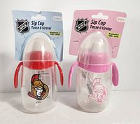 Front view showing two packaged Ottawa Senators sip cups, red and pink versions