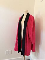 Hot pink kimono jacket on dress form showing front and length