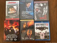 Group shot of six visible cases including Dragon Tattoo trilogy box and District 9 Blu-ray