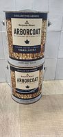 Two stacked cans of Benjamin Moore Arborcoat Silver Gray exterior stain