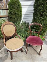 Both Victorian chairs side by side showing differing seat coverings and carved mahogany frames