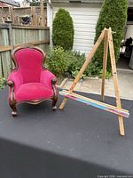 Both chair and easel on table outdoors