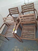 Four matching weathered hardwood slatted armchairs