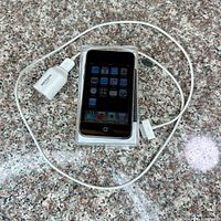 iPod touch with cable and charger on countertop