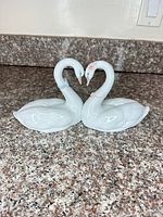Full view of twin swan figurine on countertop