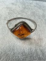 Front view of bracelet showing square amber stone and sterling bezel