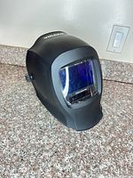 Front three-quarter view of black Vulcan welding helmet