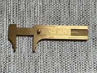 Overall view of brass 3-inch vernier caliper showing scales and Made in Germany mark