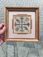 Full view of framed sandpainting held in hand