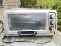 Front view of Hamilton Beach Easy Reach toaster oven showing glass door and controls