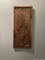 Full view of vertical wood plaque on wall