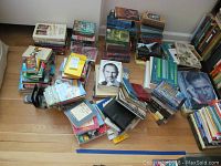 Overview of the assortment of books laid out on the floor, showing various titles and sizes.