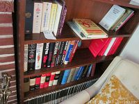 Bookshelf with a variety of books including fiction, biography, and reference titles.