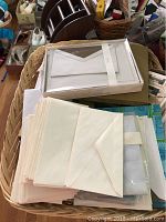 Basket with stacked envelopes and sealed paper envelopes, greeting cards.