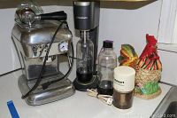 Photo showing the full lot of items on countertop: vintage Ascaso cappuccino maker, SodaStream, Cuisinart grinder, and rooster cookie jar
