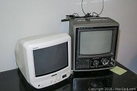 Two Sony vintage CRT TVs, white KV 9PT50 on left and gray KV 9200 on right, side view showing screens and control buttons.