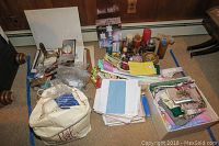 Wide view showing all items laid out on floor including bags, fabric, candles, ribbons, and boxes.