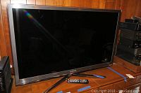 Front view of Samsung 46 inch TV with remote control placed in front.