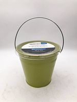 Front view of green bucket citronella candle with lid and handle