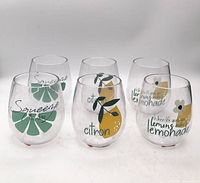 Six citrus themed stemless wine glasses arranged together