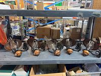 All six wall sconces on shelf showing overall style and quantity
