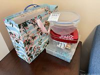 Lot overview showing floral bag, plastic bead containers stacked on table