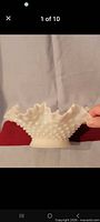 Side view of white hobnail milk glass bowl showing ruffled rim and hobnail pattern