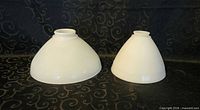 Both milk glass torchiere shades, side by side showing size difference and checkered texture