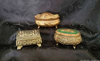 Three closed jewellery boxes showing shapes and exterior finishes
