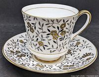 Tea cup on saucer showing pattern and gilt accents