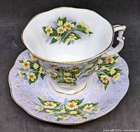 Tea cup on saucer showing exterior pattern and gold trim