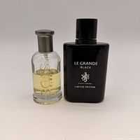 Front view of both cologne bottles showing labels and remaining liquid