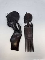 Front view of carved bust and comb