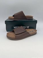 Pair of brown Mephisto slide sandals displayed on box