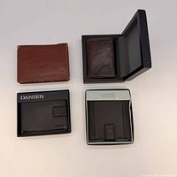 All four wallets laid out, showing colours, styles and two gift boxes