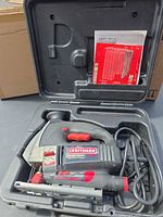 Jigsaw in carrying case with cord visible